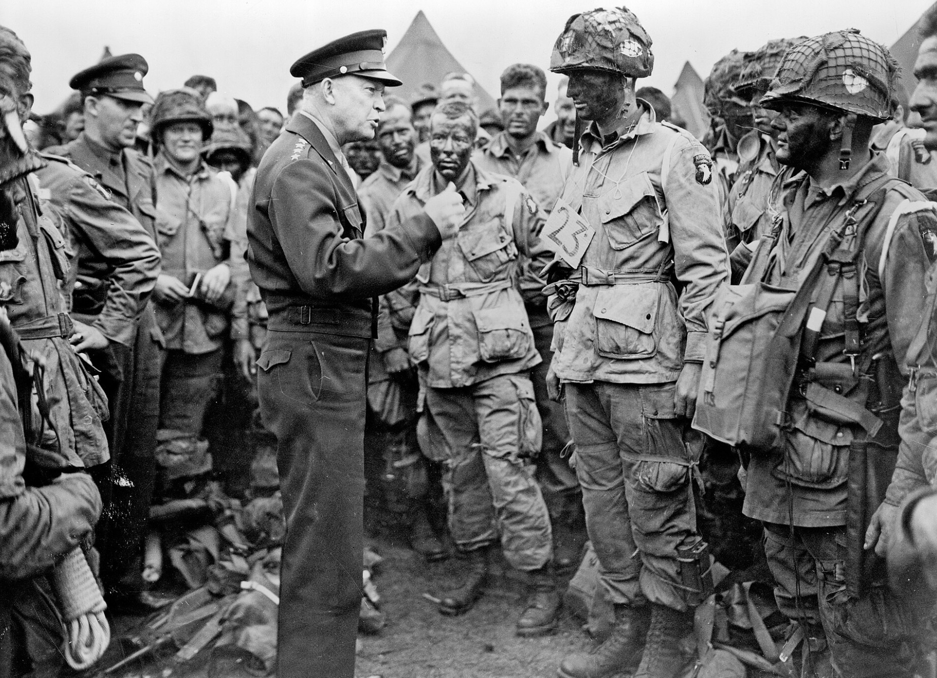 General Dwight D. Eisenhower speaking with First lieutenant Wallace C. Strobel and men of Company E, 2nd Battalion, 502nd Parachute Infantry Regiment One day before the jump at Normandy